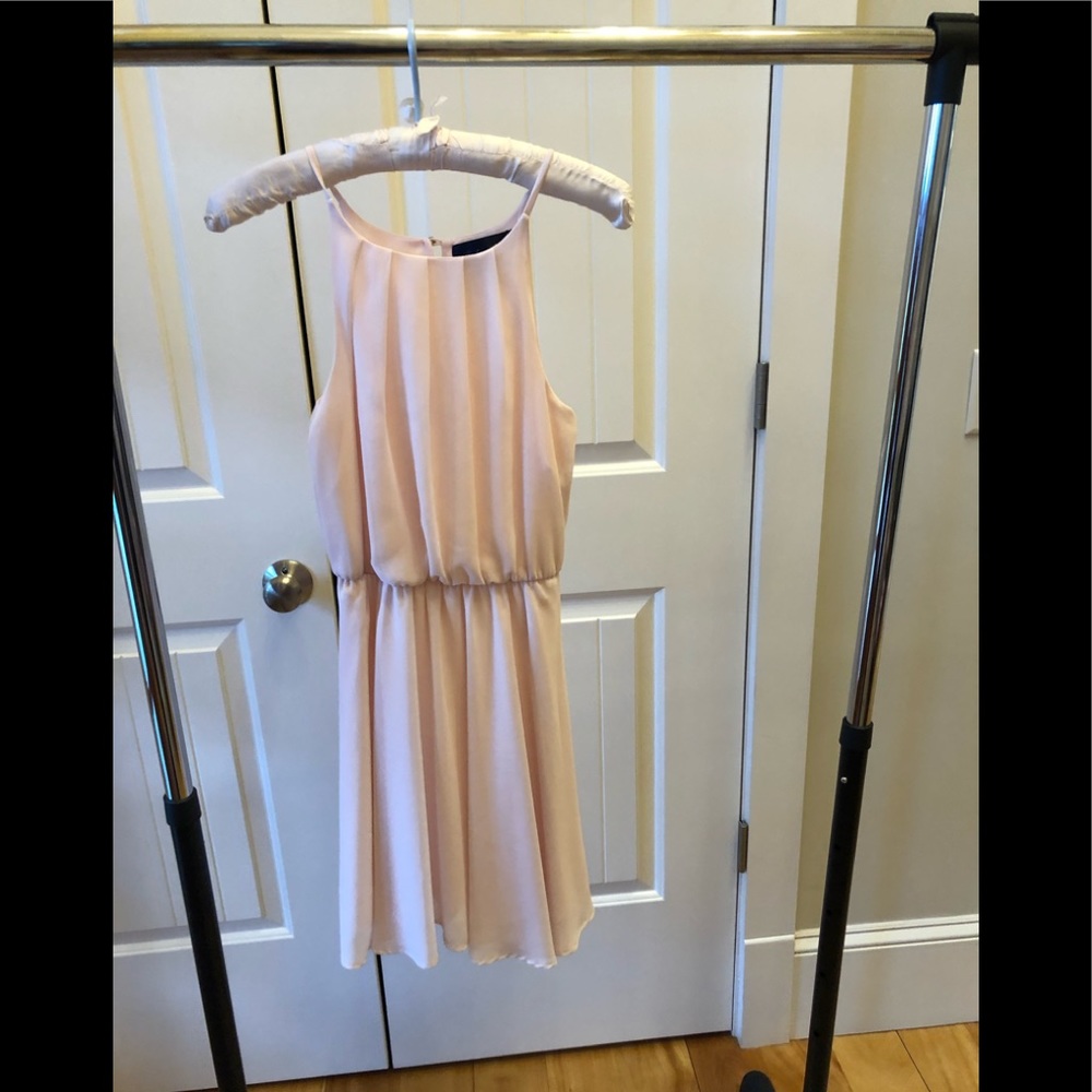 Woman’s pale pink dress
